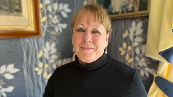 Dorothy at home waering a black jumper